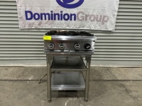 1 X 4 BURNER STAINLESS STEEL GAS COOKTOP. MOUNTED ON TWO TIER STAINLESS STEEL BENCH. NO MODEL OR SERIAL NUMBERS VISIBLE. 600 W X 800 D X 930 H.